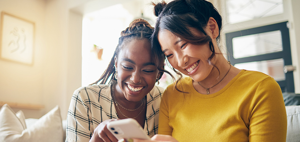 Two woman using phone